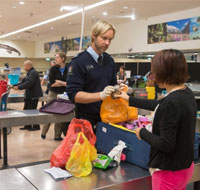 officer checking bags at Auckland airport