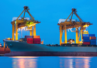 container cranes lit up against night sky