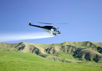 helicopter spraying fertiliser on a field