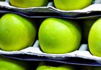 green apples sitting on a shelf