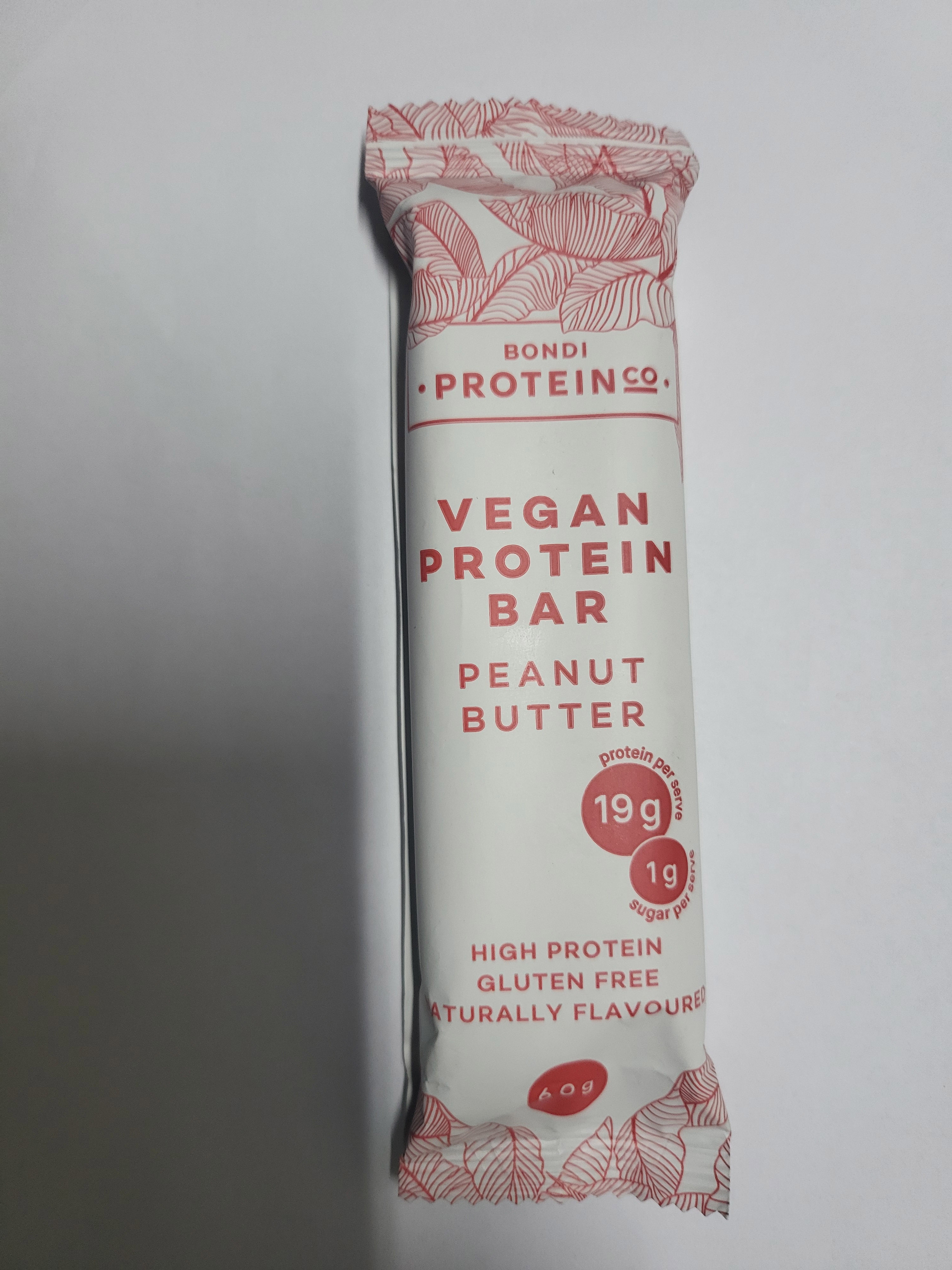 Vegan protein bar with white wrapper and red writing