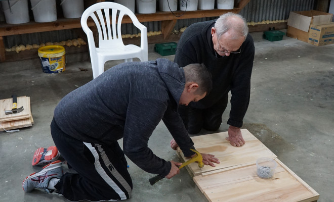 A participant at Wellington based Maranga Collective Spectrum Care gets down to business building a beehive