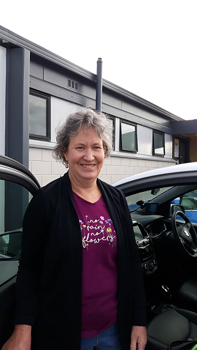 Ms Hewitt standing next to her car