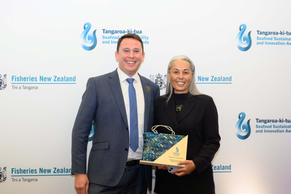Man and woman holding award.
