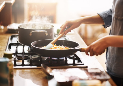 Someone pan frying food at home.