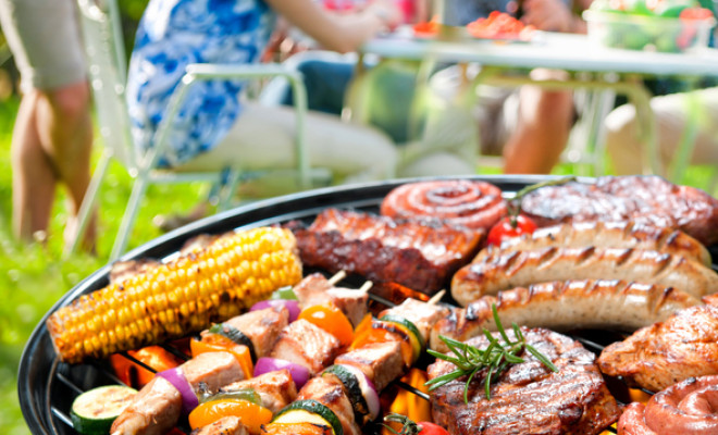 Family having a barbecue party in their garden in summer