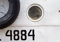 porthole and painted number 4884 on side of a ship