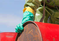person with gloves holding on to side of a drum
