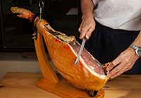 Man slicing serrano ham