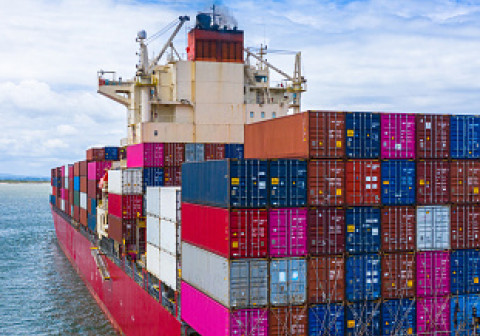Container ship stacked with lots of containers.