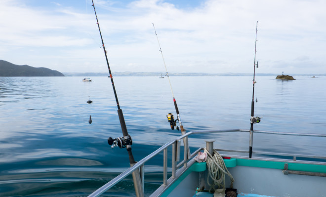 3 fishing rods on a boat