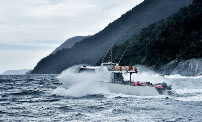 Fishing boat crashing through waves