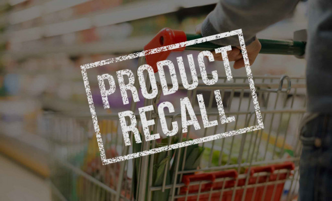 A trolley in a supermarket, with the words product recall overlaid on top