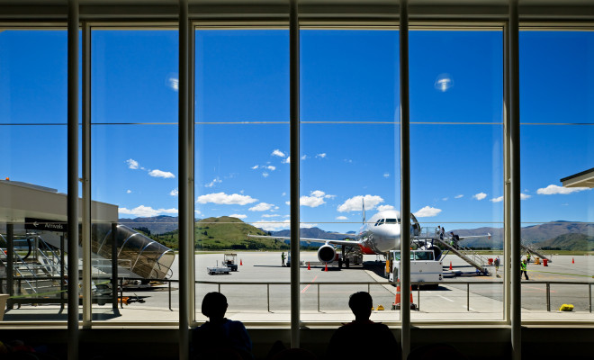 2 people waiting for their flight at Queenstown airport.